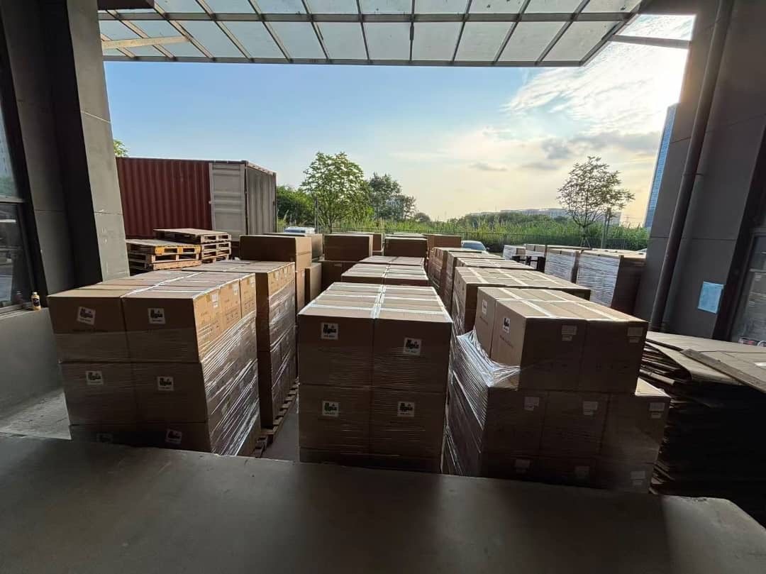 Pallets of packed cartons staged at a factory loading bay in China, ready for container loading